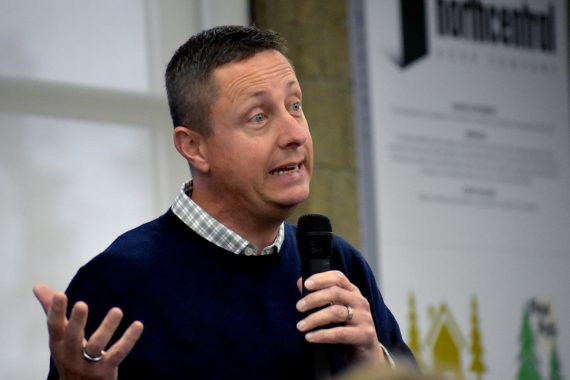 Dr. John L. Hoffman, president of NTC and Bemidji State University, speaks into a microphone