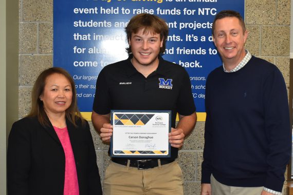 NTC student Carson Donaghue poses with NTC vice president Ketmani Kouanchao and NTC president John L. Hoffman