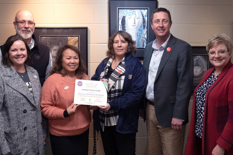 MNCEP representatives presenting a plaque to four administrators from NTC